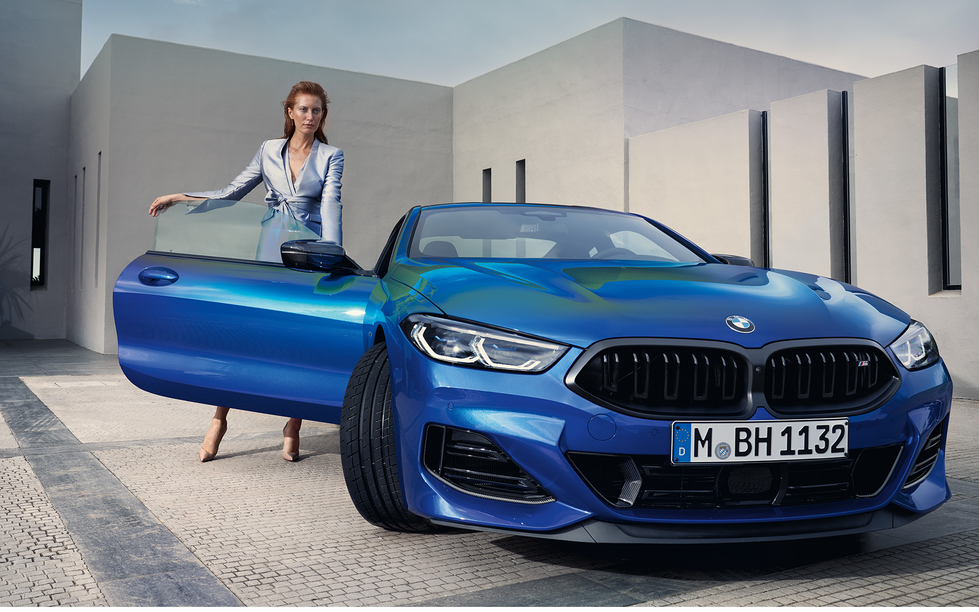 BMW M850i xDrive Coupé G15 LCI Facelift 2022 metalíza M Portimao Blue predný pohľad statický s modelkou v otvorených dverách